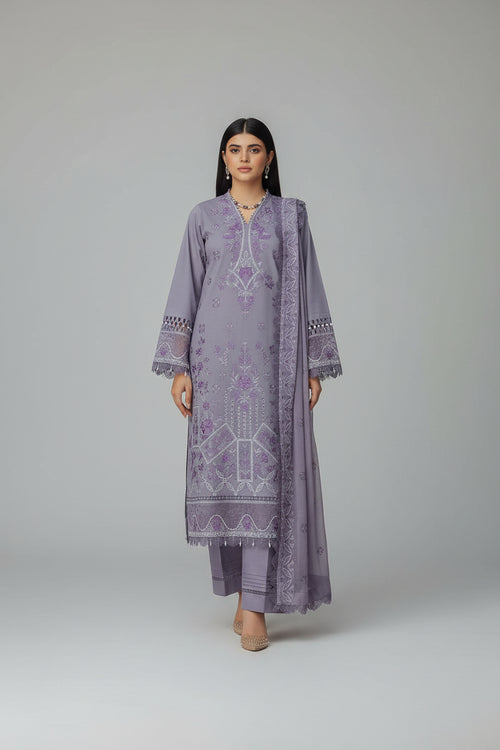 Kumash festive collection advertisement with a woman wearing a purple embroidered outfit.
