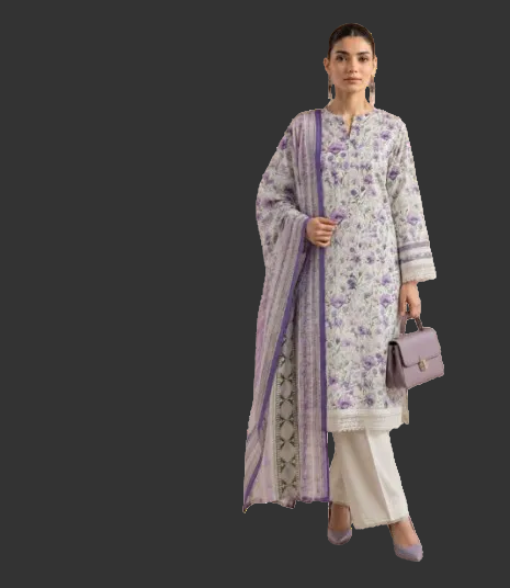 A woman modeling a traditional three-piece salwar kameez suit in a light lavender and purple floral print, paired with cream-colored pants and a matching purple dupatta, holding a small purple handbag against a plain white background.